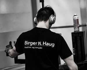 Illustrasjonsbilde av ryggen til mann med teksten Birger N. Haug "kvalitet og omtanke".